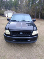 Front view of a 1998 Ford F-150 XLT 4WD in black, located in Adel, GA, with mileage of 95,000 miles.