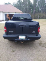 Rear view of a 1998 Ford F-150 XLT 4WD truck for sale, showcasing its condition and features.