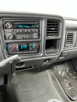 Interior dashboard of a 2006 Chevrolet Silverado 1500 showing audio controls and climate settings.