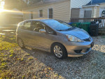 2010 Honda Fit Sport hatchback in silver with 96,000 miles parked outdoors