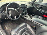 Interior view of a 2003 Chevrolet Corvette with black leather seats and dashboard features