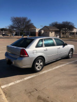 Silver 2004 Chevrolet Malibu Maxx parked in a lot, showcasing its straight body and new tires.