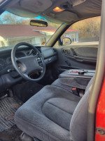 Interior view of a 1999 Dodge Dakota, featuring a well-used but dependable cabin with cloth seats.