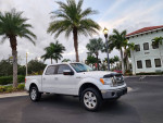 2011 Ford F-150 King Ranch 4WD parked in a scenic location with palm trees
