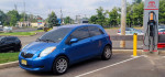 Blue Toyota Yaris 2-door hatchback parked near EV charging station, showing clean exterior and recent upgrades.