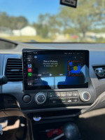 Interior view of a 2011 Honda Civic featuring new radio with wireless CarPlay and climate controls.