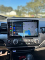 Interior of a 2011 Honda Civic featuring a touchscreen with Apple CarPlay and climate controls.