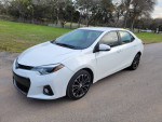2016 Toyota Corolla S FWD in white, showing stylish design and sporty wheels on a roadside