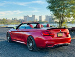 2015 BMW M4 Convertible in red with leather interior, showing off its stylish design and impressive upgrades.