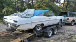 1967 Pontiac Catalina Convertible on a trailer, covered and ready for sale, showcasing its classic design and California origin.