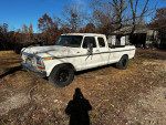 1978 Ford F250 truck with new brakes, displayed on a grassy area, showing its rustic appearance.