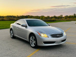 2009 INFINITI G37X AWD Coupe in silver parked outdoors at sunset