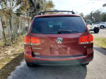 Rear view of a 2005 Volkswagen Touareg V6 SUV in red with clean title and low mileage