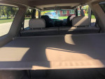 Interior view of a 2002 Toyota 4Runner showing rear seating and cargo area with tan upholstery.