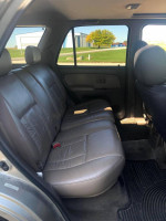 Interior view of a 2002 Toyota 4Runner showing spacious tan leather back seats and clean condition.
