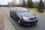 2014 Chevrolet Caprice PPV police car in dark color with low mileage parked on a quiet street