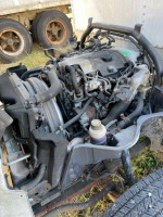 2010 Mitsubishi Fuso FE145 box truck engine and components in detail, showcasing maintenance condition and features.