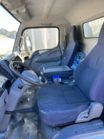 Interior view of a 2010 Mitsubishi Fuso box truck with two seats and dashboard.
