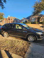 2007 Mazda CX 9 Sport SUV parked outside a house, featuring new tires and good mechanical condition.