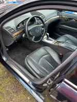 Interior view of a Mercedes-Benz with leather seats, automatic controls, and a sleek design.