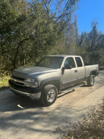 2001 Chevrolet Silverado 2500 4x4 parked on a dirt road, showcasing its clean title and low mileage.