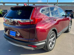 2019 Honda CR-V EX FWD in Basque Red Pearl II parked outdoors, showcasing its stylish design and spacious features.