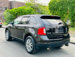 2013 Ford Edge SEL FWD parked on the street with a clean exterior and alloy wheels, ready for a new owner.