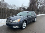 2011 Subaru Outback in excellent condition, parked on snowy street, showcasing reliability and maintenance.