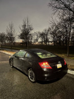2012 Honda Civic LX coupe parked in a rainy setting, featuring clean exterior and alloy wheels.