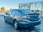 2013 Honda Civic Hybrid in good condition with alloy wheels and rear camera parked in urban setting.