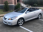 2008 Toyota Solara SLE Convertible in silver with low mileage for sale, parked in a residential area.