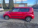 2013 Kia Soul in red, showcasing clean body, alloy wheels, and good condition, perfect for car enthusiasts.