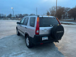 2002 Honda CR-V with all-wheel drive, manual transmission, and new tires parked in a snowy area.