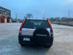 Rear view of a well-maintained 2002 Honda CR-V with new tires, parked in an outdoor lot.