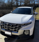Front view of a 2022 Hyundai Santa Cruz SEL AWD in Ice White color, showcasing modern design and features.