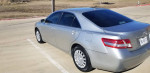 2010 Toyota Camry in silver, low mileage, well-maintained, parked on a sunny day.