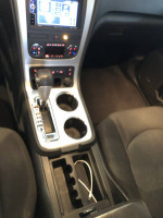 Interior view of a 2011 GMC Acadia showing dashboard and gear shift