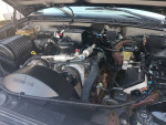 1999 Chevrolet Suburban engine compartment showcasing new components and maintenance details.
