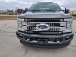Front view of a 2017 Ford F250 Platinum truck with a clean title and 98k miles, showcasing its robust design.