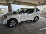 2011 Nissan Armada 4X4 SUV with leather seats in a parking garage, well-maintained and ready to drive.