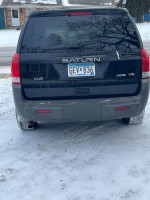 2004 Saturn Vue AWD V6 rear view with snowy background, clean title, needs front subframe repair.