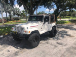 2002 Jeep Wrangler Sahara Edition with 33-inch wheels, lifted and customized, parked in a scenic location