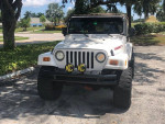2002 Jeep Wrangler Sahara 4WD, lifted with 33-inch wheels, LED headlights and Bimini roof.