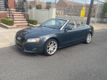 2010 Audi A5 premium convertible parked on the street, showcasing its sleek design and modern features.