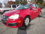 2007 Volkswagen Jetta in fire engine red, one owner, well-maintained with great body and new tires