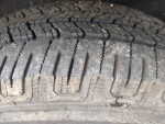 Close-up of the tire tread on a 2003 Honda Pilot, showcasing good condition and depth.