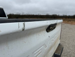 Close-up of the rear tailgate of a 2021 Chevrolet Silverado 1500 Work Truck with dirt marks