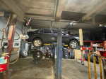 1997 Toyota Tercel on a lift in a garage, highlighting its reliability and recent maintenance.