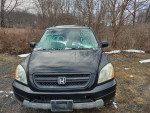 Front view of a 2003 Honda Pilot with 87,000 miles, showcasing black color, snowy windshield, and 4x4 capability.