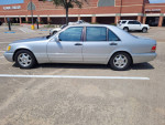 1999 Mercedes S420 parked in a lot, showcasing its silver exterior and alloy wheels.